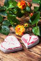 Symbolic wooden heart and flowers