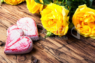 Symbolic wooden heart and flowers