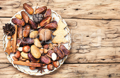 Christmas plate with nuts, spices and cedar cone