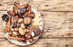 Christmas plate with nuts, spices and cedar cone