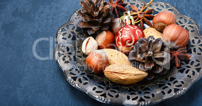 Christmas composition with nuts, spices and cone