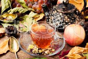 Cup of tea with autumn leaves