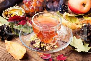 Cup of tea with autumn leaves