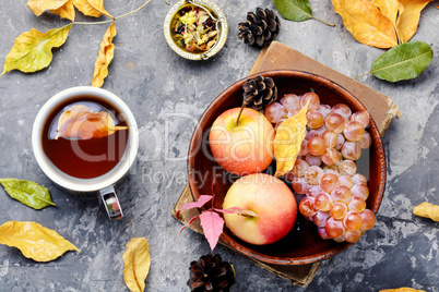 Cup of tea with autumn leaves