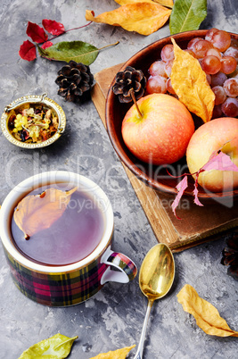 Cup of tea with autumn leaves