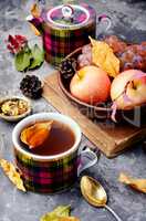 Cup of tea with autumn leaves