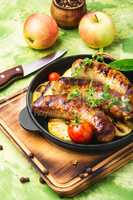 Sausages fried with spices and apple