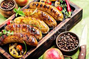 Sausages fried with spices and apple