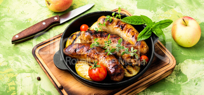 Sausages fried with spices and apple