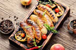 Grilled sausages on cutting board