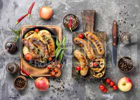 Grilled sausages on cutting board