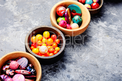 Colorful beads in wooden bowls