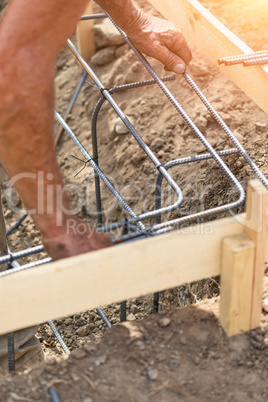 Worker Securing Steel Rebar Framing With Wire Plier Cutter Tool