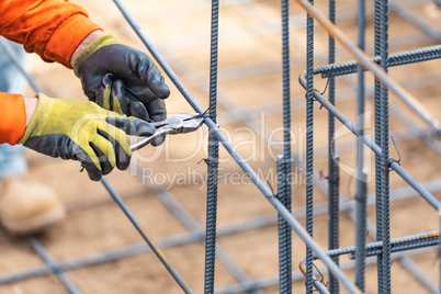 Worker Securing Steel Rebar Framing With Wire Plier Cutter Tool