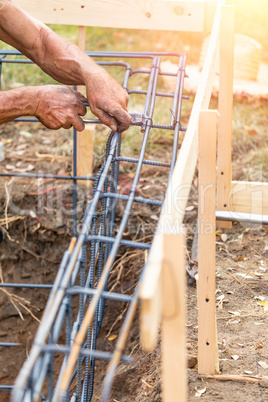 Worker Securing Steel Rebar Framing With Wire Plier Cutter Tool