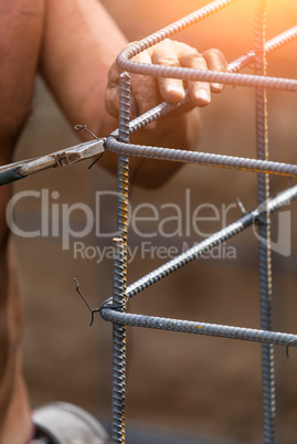 Worker Securing Steel Rebar Framing With Wire Plier Cutter Tool