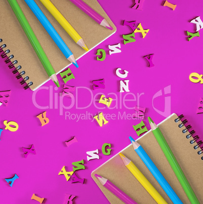 two notebook and multicolored wooden pencils
