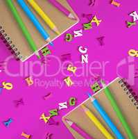 two notebook and multicolored wooden pencils