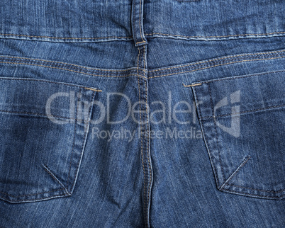 fragment of the back of blue textile jeans with pockets