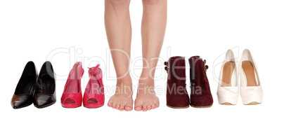 Woman legs standing between heels and boots