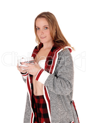 Woman in a bath robe holding a big mug