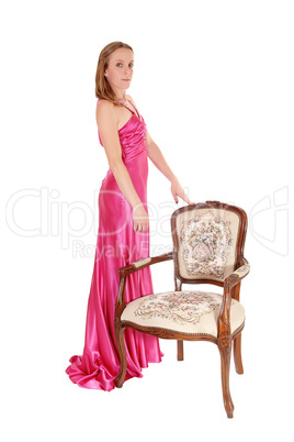 Gorgeous woman standing is a long pink dress