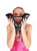 Pretty woman holding her heels over face
