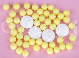 yellow vitamins on pink background