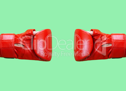 two female hands is wearing a red leather boxing glove on a gree