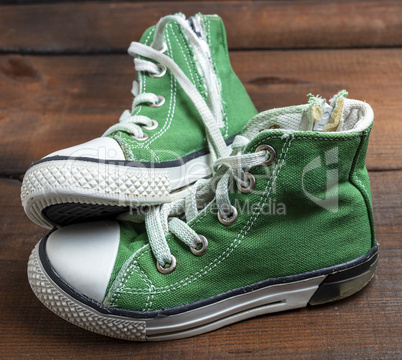 pair of worn green textile sneakers