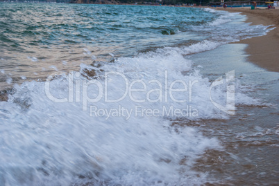 sea surf on a sandy beach on the coast in Greece