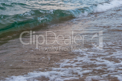 sea surf on a sandy beach on the coast in Greece
