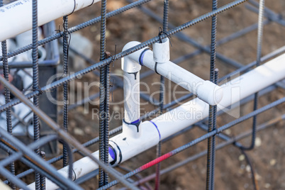 Newly Installed PVC Plumbing Pipes and Steel Rebar Configuration