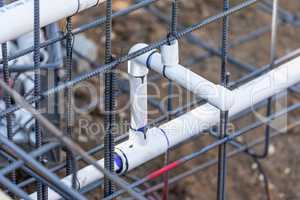 Newly Installed PVC Plumbing Pipes and Steel Rebar Configuration