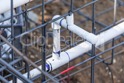 Newly Installed PVC Plumbing Pipes and Steel Rebar Configuration