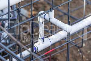 Newly Installed PVC Plumbing Pipes and Steel Rebar Configuration