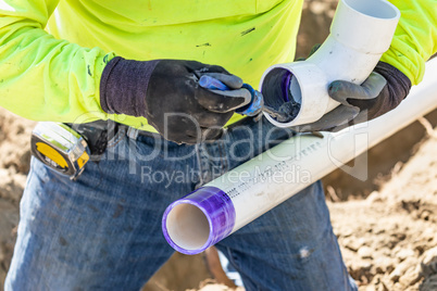 Plumber Applying Pipe Cleaner, Primer and Glue to PVC Pipe