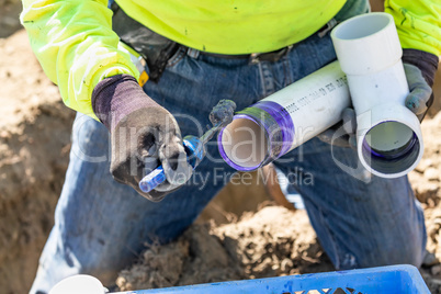 Plumber Applying Pipe Cleaner, Primer and Glue to PVC Pipe