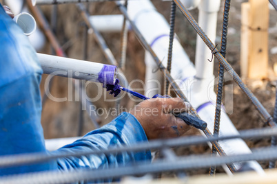 Plumber Applying Pipe Cleaner, Primer and Glue to PVC Pipes