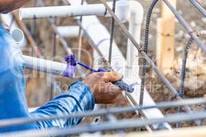 Plumber Applying Pipe Cleaner, Primer and Glue to PVC Pipes