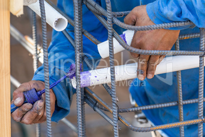 Plumber Applying Pipe Cleaner, Primer and Glue to PVC Pipe