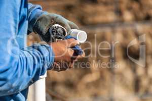 Plumber Applying Pipe Cleaner, Primer and Glue to PVC Pipe