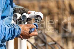 Plumber Applying Pipe Cleaner, Primer and Glue to PVC Pipe