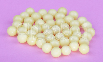 yellow vitamins on pink background