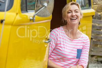 Happy Middle Aged Woman Sitting in Camper Van or Bus
