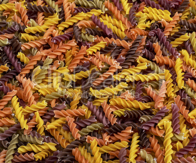 multicolored spiral raw pasta fusilli