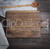 empty old brown wooden cutting board and spoon