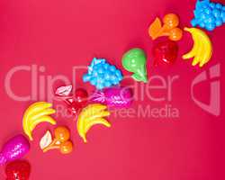 abstract red background with childrens plastic toys