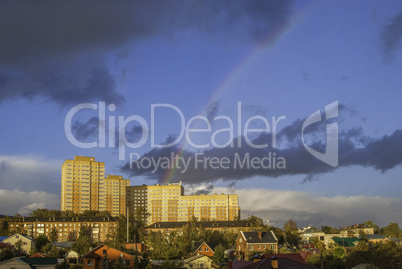 Rainbow after rain over the houses in the city