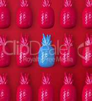 many red and one blue plastic toy pineapples